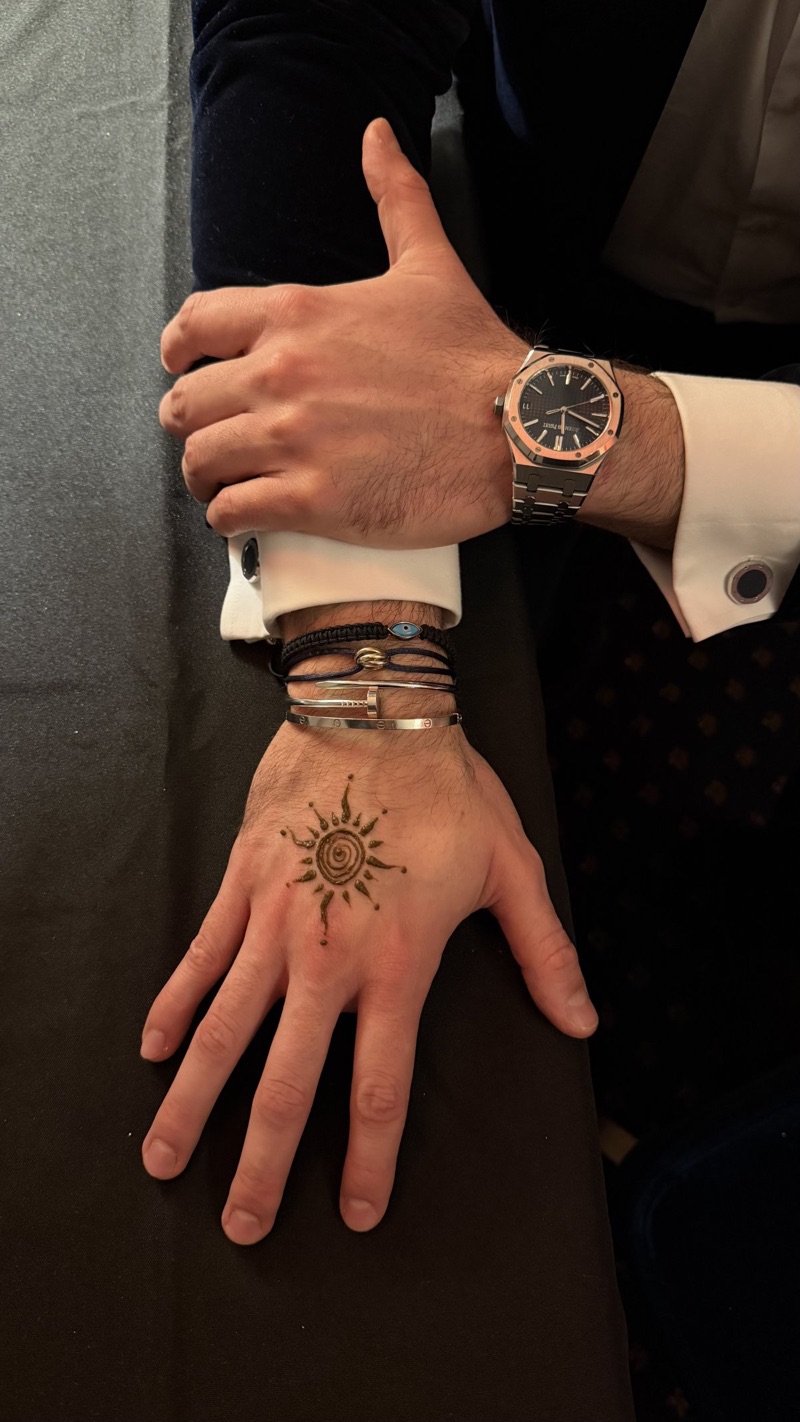 Henna on a man's hand, wearing an Audemars Piguet watch in Geneva.