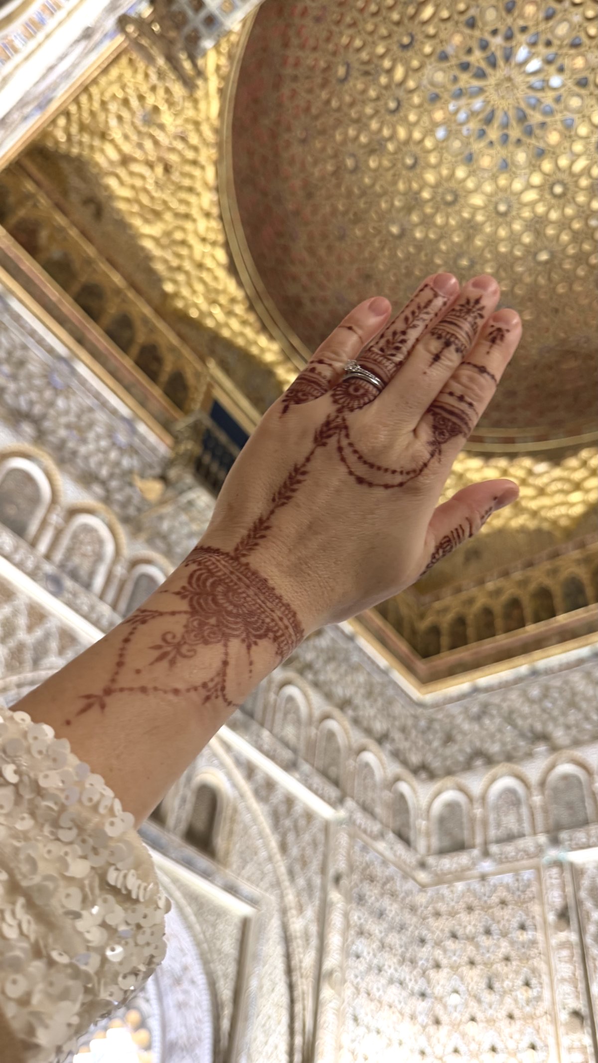 Bridal henna on ornate background of Alhambra
